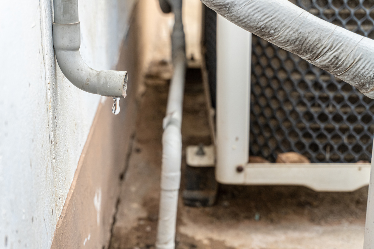 Water leak near air conditioner indicating possible need for repair in Fresno home.